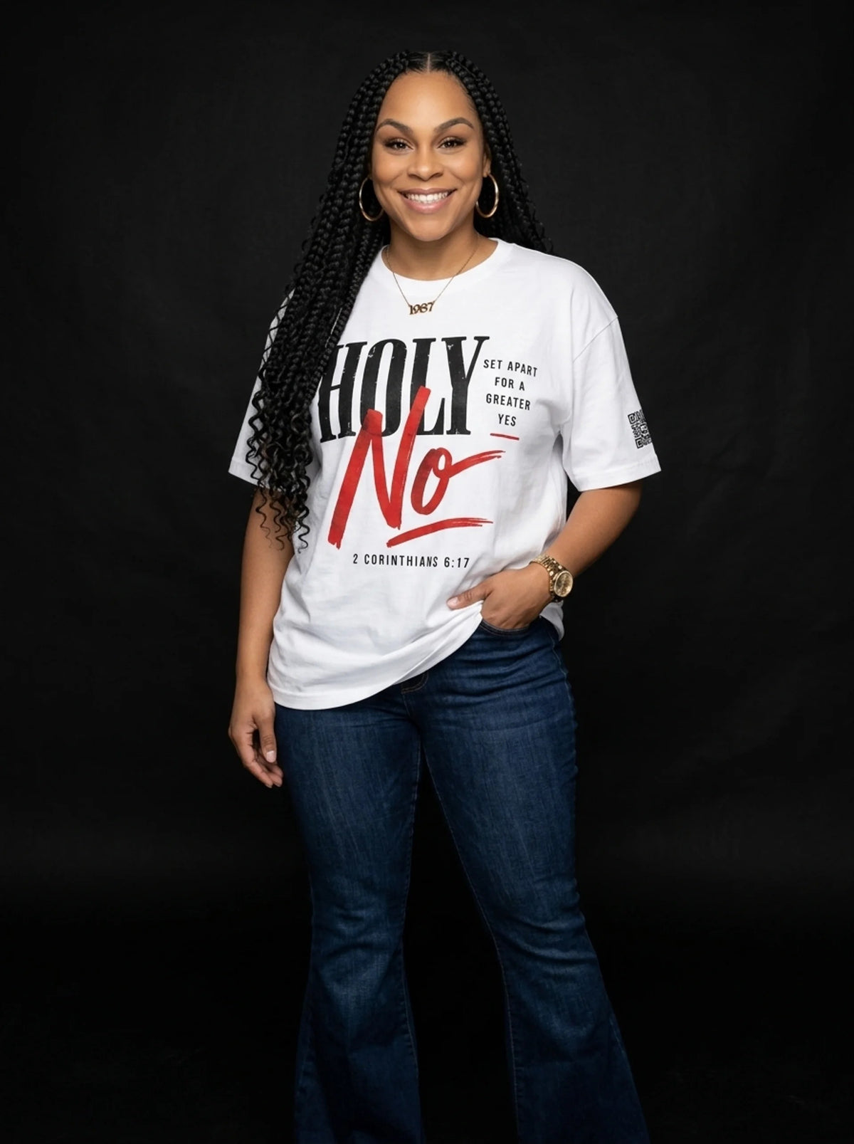 ALowe McCants smiling in the white Holy No tee from The Gathering Collection