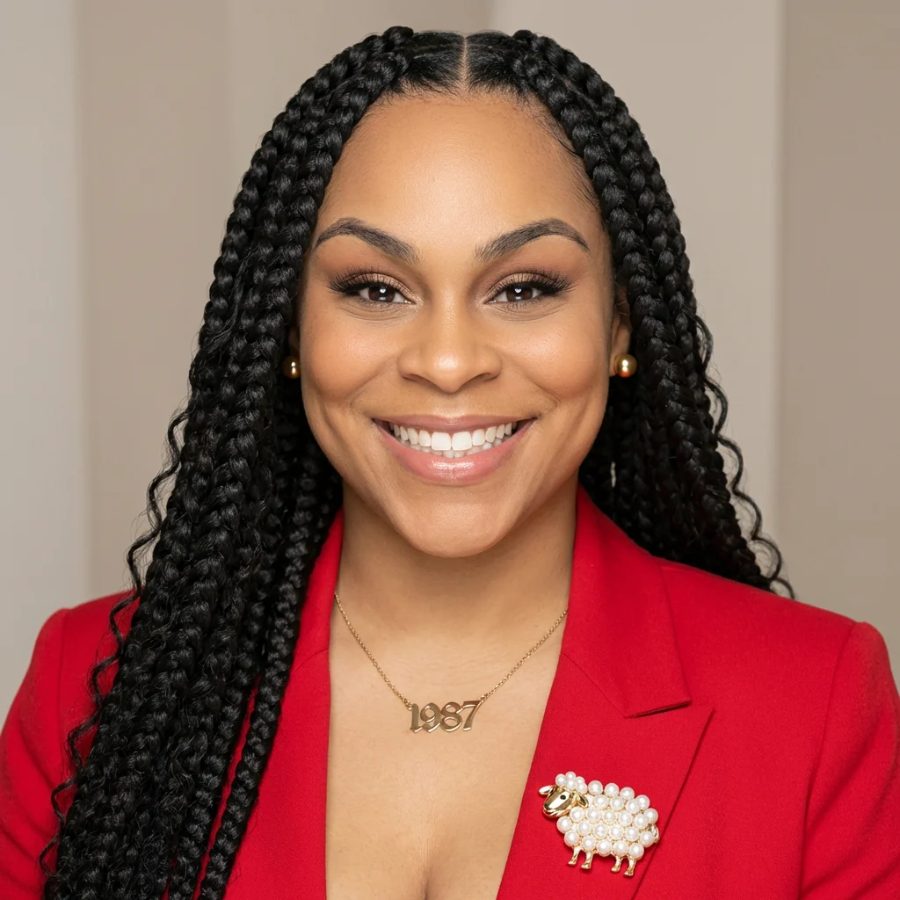 Headshot of ALowe McCants smiling in a red blazer